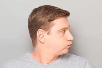 Obraz premium Portrait of disappointed man sighing sadly, looking tired and bored