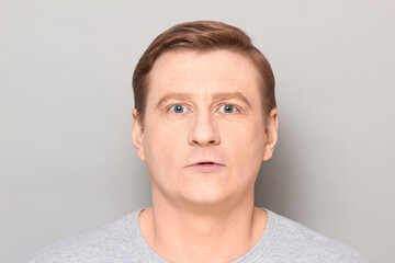 Fototapeta premium Portrait of amazed mature man looking at something unbelievable