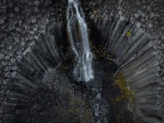 Aerial drone view of Studlafoss waterfall with basalt columns in East Iceland. Icelandic nature landscape from above