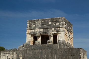 Tourism. Ancient Maya culture and civilization. Closeup of the stone building ruins at the Great ball court in the Mayan city of Chichen Itza in Mexico.
