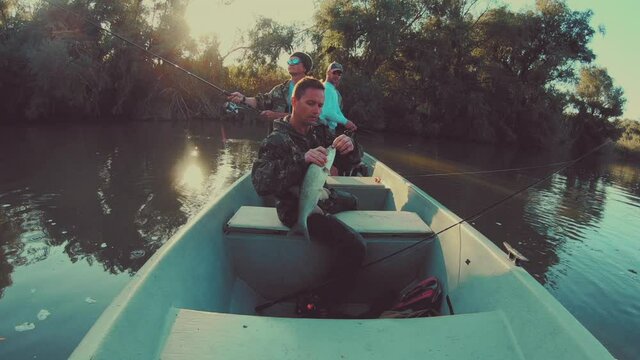 Angler takes out the lure from aps's jaws