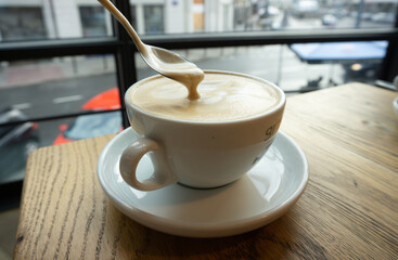A cup of cappuccino with milk