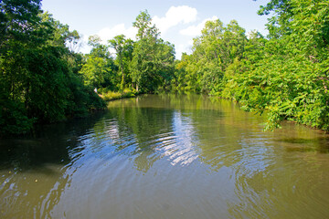 Clouds and trees reflecting in the waters of the Delaware and Raritan Canal at Colonial Park. -01