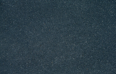 Dark textured grainy concrete background close-up.