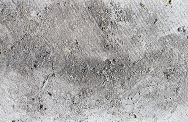 Textured weathered gray concrete wall, close-up.
