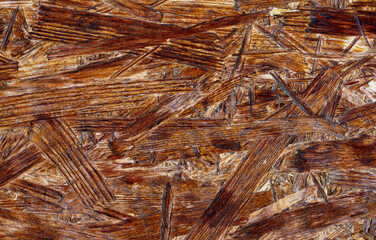 Brown pressed wooden textured bakground, waferboard close-up.