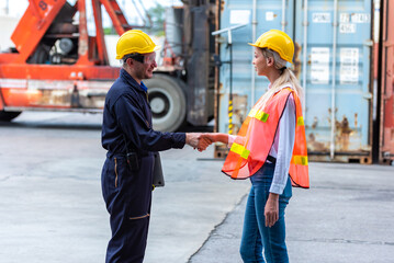 Business people shaking hands together at cargo warehouse port.