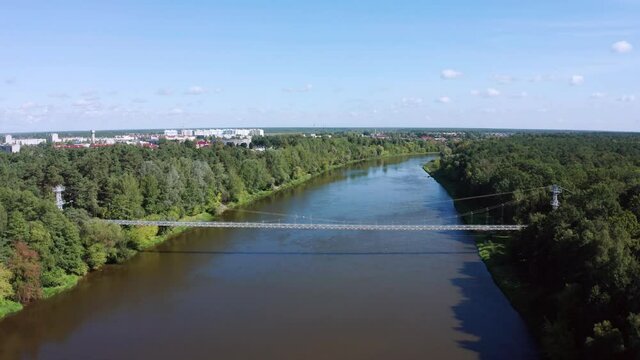 flight over suspension pedestrian bridge through the Neman river in the city Mosty, Republic of Belarus.