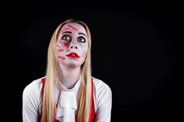 blond haired witch with green and blue eyes on a black background for Halloween