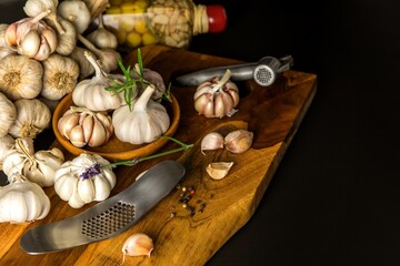 Fototapeta na wymiar Garlic Cloves and Bulb in vintage wooden bowl. Healthy food. Garlic on a wooden background. Traditional spices.