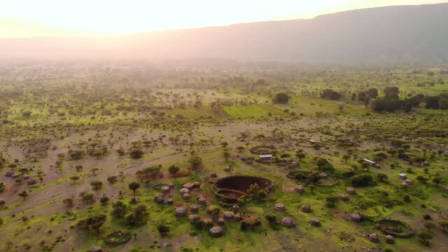 Aerial Drone Shot. Traditional Masai village at Sunset time near Mto wa Mbu, Arusha, Tanzania.