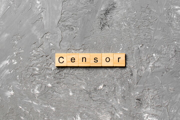 Censor word written on wood block. Censor text on cement table for your desing, concept