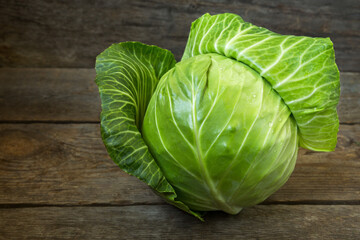 Fresh cabbage on an old wooden background