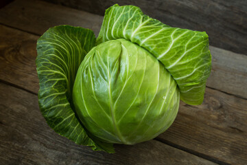 Fresh cabbage on an old wooden background