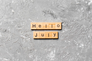 hello july word written on wood block. hello july text on table, concept