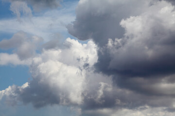 Telephoto closeup photo of dramatic clouds at blue sky