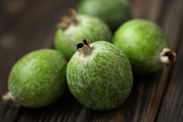Fresh feijoa close-up on a wooden background. Selective focus