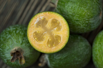Fresh feijoa close-up on a wooden background. Selective focus