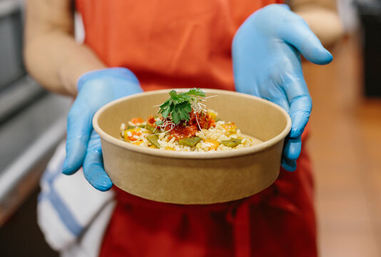 A Cook Presents Her Gourmet Rice Salad In A Compostable Take-away Container