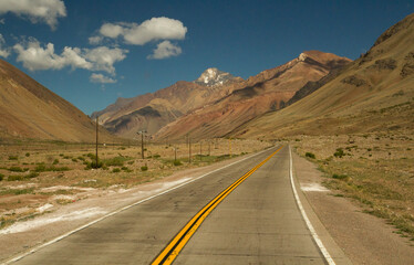 Traveling. Getaway. Empty rural road across the valley and mountains. 