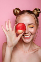 The girl smiles with a peach and bright makeup on the summer background. summer mood