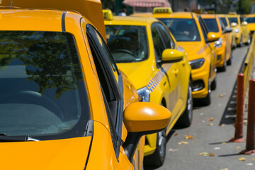 Yellow taxi cars on the empty street, taxi cab parking lot with yellow cars standing, set of taxicabs in the streets, taxis