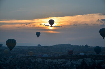 Colorful Hot air balloon flying over rocks and valley landscape at Cappadocia near Goreme Turkey