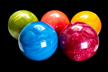 colorful bowling balls isolated on black background.