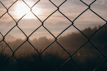 Landscape behind a mesh fence