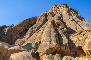 The caves of the ancient rock monastery of Selime, carved into the mountains in the valley of Ihlara, Cappadocia, Turkey
