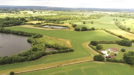 Fototapeta na wymiar Aerial landscape view, Tonbridge, countryside, England, UK, Kent. Summer rural landscape. Rounded dron movement to the right.
