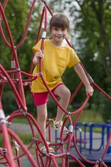 Fotobehang Schattig 6 jaar oud meisje in het gele t-shirt op de speelplaats. © Albert Ziganshin