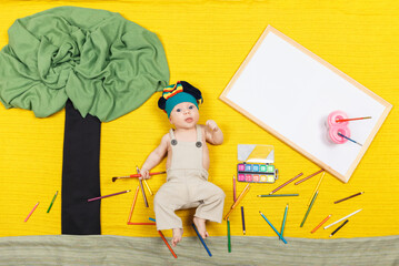 Cute toddler boy painting with paints color and brushes a picture