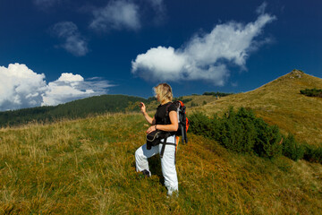 girl with smartphone in the carpathians on the top of the mountain
