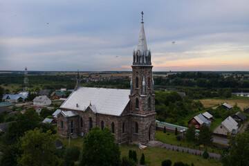 A beautiful church made of unusual stone in a small village. Eastern Europe . Aerial photography