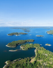 Obraz premium Aerial view of beautiful islands with green trees and rocks on the baltic sea at sunny summer day. Colorful landscape with islands. Top view. Saaristomeri, Finland.