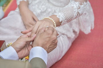 Wedding ring.Groom put the wedding ring on bride.Thai traditional wedding ceramony decoration