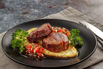 Beef medallions with tomato salsa and cream polenta