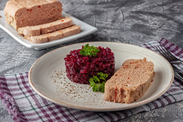 Fresh chicken terrine with beetroot confiture and parsley on a platter