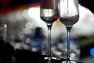 very close glass of champagne while filling it with a drink 