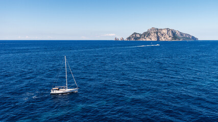 sailing ship in front of the Faraglioni of Capri, Naples, Italy.