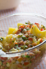 Delicious cassava with vinaigrette sauce. Made with cooked cassava, tomatoes, onions, chives and vinegar. Served in a glass jar with the aid of a spoon.