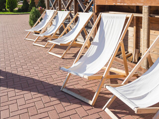 Deckchairs are at cafe's verandah. Visitors can enjoy the good weather and sunbathe in lounge...