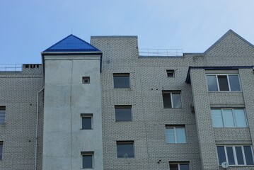 part of a large private house with a row of windows against the sky