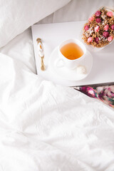 breakfast in bed with fruits and pastries on a tray -waffles, croissants, coffe and juice