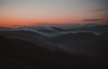 sunset in the mountains over the clouds