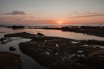 Fototapeta premium sunset on the beach over tide pools
