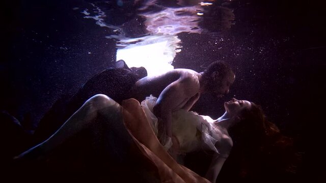 lovers are hugging passionately underwater, sensual subaquatic shot