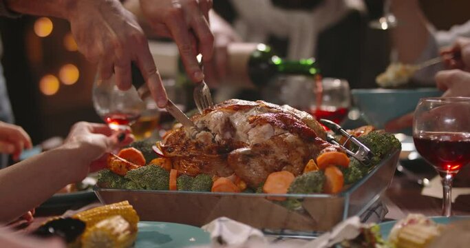 Close up shot of people eating delicious roasted turkey during thanksgiving or christmas dinner party, filling up plates and glasses - food and drink, celebration 4k footage