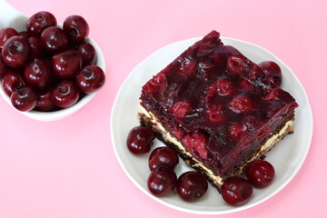 cherries and cherry cake clsoe up on pink background
